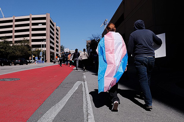 Dylan Yeary (L) wears the trans flag during a rally for trans rights in Austin, Texas, in February. A study shows that adding more terms for gender identity and sexual orientation help LGBTQ+ youth feel accepted.
Mandatory Credit:	Aaron E. Martinez/American-State/USA Today Network/Reuters