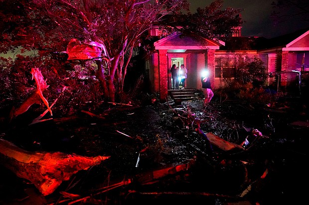 People survey the damage in Arabi, Louisiana, on March 22. A tornado tore through parts of New Orleans on Tuesday night, ripping down power lines and scattering debris in a part of the city that was badly hit by Hurricane Katrina 17 years ago.
Mandatory Credit:	Gerald Herbert/AP