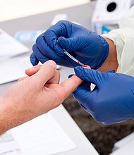 A health worker takes a drop of blood for the Covid-19 antibody test in Torrance, California, in May 2020. Scientists are searching for a test to measure immunity against the virus.
Mandatory Credit:	Valerie Macon/AFP/Getty Images