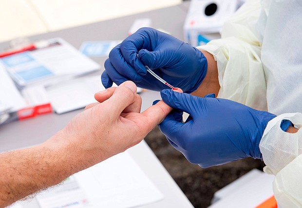 A health worker takes a drop of blood for the Covid-19 antibody test in Torrance, California, in May 2020. Scientists are searching for a test to measure immunity against the virus.
Mandatory Credit:	Valerie Macon/AFP/Getty Images