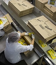 Workers pack boxes with packets of Nesquik in Samara, Russia, in September 2014. Nestlé is halting the sale of Nesquik, among other of its brands, in Russia.
Mandatory Credit:	Andrey Rudakov/Bloomberg/Getty Images