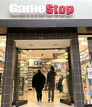 Customers enter a GameStop store in December 2021 in San Rafael, California. Shares of GameStop and AMC are surging again.
Mandatory Credit:	Justin Sullivan/Getty Images