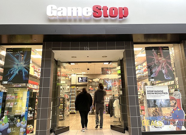 Customers enter a GameStop store in December 2021 in San Rafael, California. Shares of GameStop and AMC are surging again.
Mandatory Credit:	Justin Sullivan/Getty Images