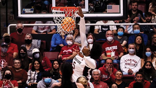 Fran Belibi, a 6-foot-1 junior at Stanford University, throws down the third dunk in NCAA women’s tournament history March 18 during the defending national champion’s game against Montana State University.