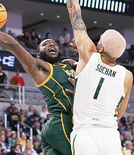 Norfolk State University senior Joe Bryant Jr. shoots over Baylor University’s Jeremy Sochan during the Spartans’ 85-47 loss March 17 during the first round of the NCAA Tournament. Bryant led the Spartans with 15 points.