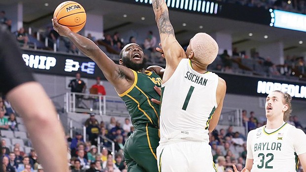 Norfolk State University senior Joe Bryant Jr. shoots over Baylor University’s Jeremy Sochan during the Spartans’ 85-47 loss March 17 during the first round of the NCAA Tournament. Bryant led the Spartans with 15 points.