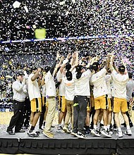 The Randolph-Macon CollegeYellow Jackets celebrate their 75-45 victory over Elmhurst University of Illinois to claim the NCAA Division III Tournament title March 19 in Fort Wayne, Ind.