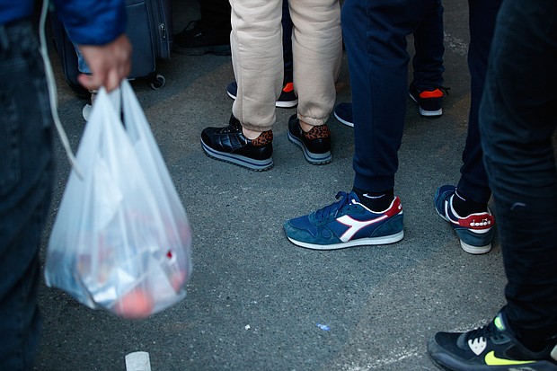 People are seen waiting in line for food at a temporary handout point in Warsaw, Poland on March 18. The economic fallout from Russia's invasion of Ukraine is spilling over to the rest of the world.
Mandatory Credit:	STR/NurPhoto/Getty Images