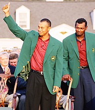 Pictured are Tiger Woods (L) and Vijay Singh during the presentation ceremony of the 2001 Masters tournament in Augusta, Georgia. The clubs that Woods used to win the "Tiger Slam" are up for sale for the first time in more than a decade.
Mandatory Credit:	Augusta National/Getty Images