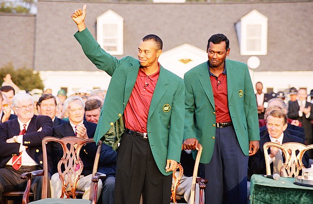 Pictured are Tiger Woods (L) and Vijay Singh during the presentation ceremony of the 2001 Masters tournament in Augusta, Georgia. The clubs that Woods used to win the "Tiger Slam" are up for sale for the first time in more than a decade.
Mandatory Credit:	Augusta National/Getty Images