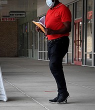 Pedestrians walk by a "Now Hiring" sign outside a store in August 2021 in Arlington, Virginia. US businesses had 11.3 million job openings to fill in February.
Mandatory Credit:	Olivier Douliery/AFP/Getty Images