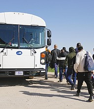 Asylum seekers board a bus to be transported to an immigration facility, after crossing the Mexico/USA border into Yuma on February 21 in Yuma, Arizona.
Mandatory Credit:	Katie McTiernan/Anadolu Agency/Getty Images