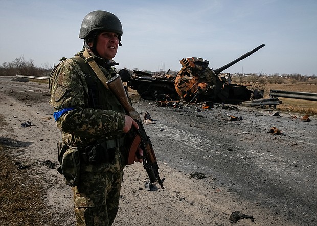 A Ukrainian serviceman stands near the wreck of a Russian tank on the front lines in the Kyiv region, Ukraine on March 28.
Mandatory Credit: Gleb Garanich/Reuters