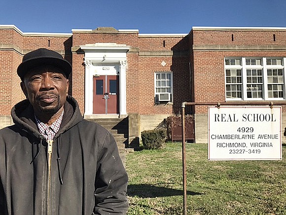 In this photo from 2017, Kenneth Williams, CEO of Adult Alternative Program, stands in front of the vacant REAL School building at 4929 Chamberlayne Ave.