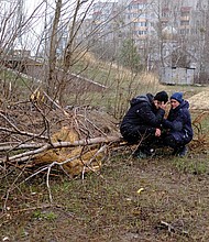 Vladimir is comforted by his wife, Anna, near the mass grave in Bucha.
Mandatory Credit:	Vasco Cotovio/CNN