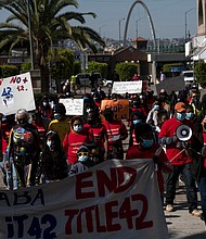 Migrants and asylum seekers march to protest against Title 42 policy in Tijuana, Mexico, on March 21. Three Republican-led states are suing the Biden administration seeking to stop it from ending Title 42.
Mandatory Credit:	GUILLERMO ARIAS/AFP/Getty Images