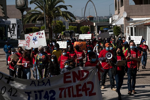 Migrants and asylum seekers march to protest against Title 42 policy in Tijuana, Mexico, on March 21. Three Republican-led states are suing the Biden administration seeking to stop it from ending Title 42.
Mandatory Credit:	GUILLERMO ARIAS/AFP/Getty Images