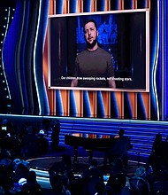 President of Ukraine, Volodymyr Zelensky, speaks on screen at the 64th annual Grammy Awards on Sunday.
Mandatory Credit:	Chris Pizzello/Invision/AP