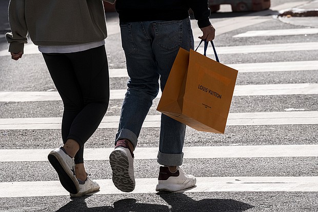 A pedestrian carries a Louis Vuitton shopping bag in San Francisco in September 2021. Higher prices and geopolitical concerns may soon slow demands for luxury goods.
Mandatory Credit:	David Paul Morris/Bloomberg/Getty Images