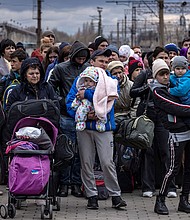 Families arrive at the main train station as they flee the eastern city of Kramatorsk, in the Donbass region on April 4, 2022, amid Russian invasion of Ukraine.