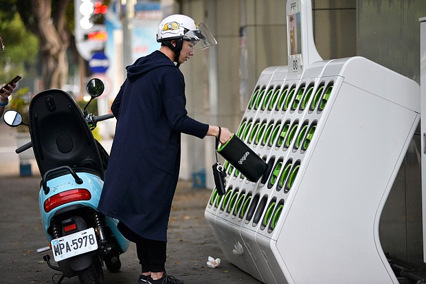 A rider swapping batteries at a Gogoro GoStation in Taipei in 2018. Gogoro, a Taiwanese electric scooter startup that's backed by Al Gore and one of Apple's biggest suppliers, is about to have its day on Wall Street.
Mandatory Credit:	CHRIS STOWERS/AFP/Getty Images