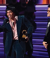 Anderson .Paak, left, and Bruno Mars of Silk Sonic accept the award for record of the year for “Leave the Door Open” at Sunday’s Grammy Awards show.