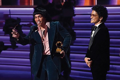 Anderson .Paak, left, and Bruno Mars of Silk Sonic accept the award for record of the year for “Leave the Door Open” at Sunday’s Grammy Awards show.