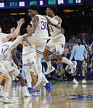 University of Kansas players leap for joy Monday night after the final buzzer sounded and they clinched the NCAA Tournament title with a 72-69 win over the University of North Carolina.