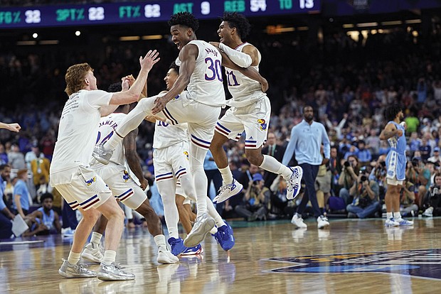 University of Kansas players leap for joy Monday night after the final buzzer sounded and they clinched the NCAA Tournament title with a 72-69 win over the University of North Carolina.