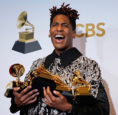 Jon Batiste poses in the press room at the MGM Grand Garden Arena with the five Grammy Awards he won Sunday at the 64th Annual Grammy Awards in Las Vegas. He won for best American roots performance for “Cry;” best American roots song for “Cry;” best music video for “Freedom;” best score soundtrack for visual media for “Soul;” and album of the year for “We Are.”