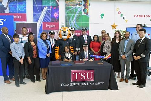 Seated, Dr. Lesia L. Crumpton-Young, TSU President, and Lee Kinnebrew, Southwest’s Vice President of Flight Operations surrounded by TSU’s Aviation program students and United Airlines