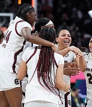 The University of South Carolina women’s team celebrates on the court after winning the NCAA title Sunday in a 64-49 victory over the University of Connecticut.