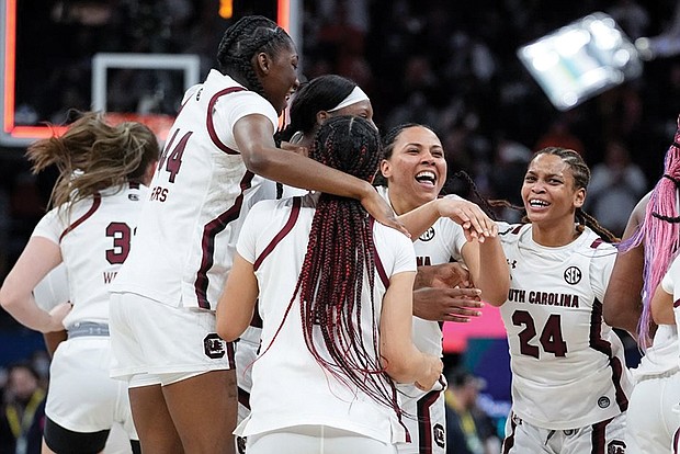 The University of South Carolina women’s team celebrates on the court after winning the NCAA title Sunday in a 64-49 victory over the University of Connecticut.