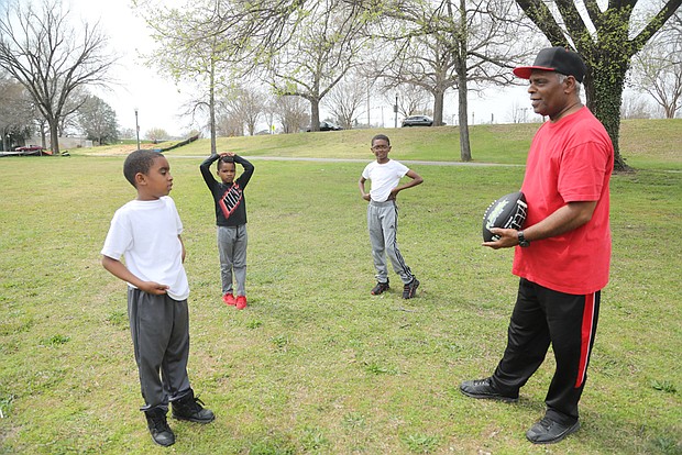 It’s spring break for Henrico brothers Neal Joyner, 9, left; his brother, Nasir Joyner, 6, center; and their cousin, Isaiah Banks, 11, of Chesterfield. But the three were “working out” Tuesday at Byrd Park with their grandfather and coach, Ronnie Harris. They were having fun running to catch their grandfather’s long passes on the grassy stretch by Fountain Lake. Mr. Harris played neighborhood football growing up, while one of the boys played for the Kanawha Red Hawks, a pee-wee team in Henrico. (Regina H. Boone/Richmond Free Press)