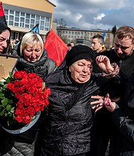 Mourners react during the funeral ceremony of Ukrainian serviceman Roman Tiaka, 47, who was killed during Russia's invasion of the Ukraine, in Stebnyk, Lviv region on April 12.
Mandatory Credit:	Viacheslav Ratynskyi/Reuters