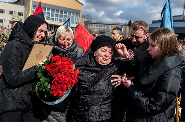 Mourners react during the funeral ceremony of Ukrainian serviceman Roman Tiaka, 47, who was killed during Russia's invasion of the Ukraine, in Stebnyk, Lviv region on April 12.
Mandatory Credit:	Viacheslav Ratynskyi/Reuters