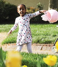 Lydia Bayou, 4, of Glen Allen looks to fill her Easter basket Monday during an Easter egg hunt hosted by Gov. Glenn A. Youngkin and First Lady Suzanne S. Youngkin outside the Executive Mansion in Capitol Square in Downtown. The seasonal event was for the staff of the Children’s Hospital of Richmond and their children. Lydia was accompanied by her parents, Fisseha Bayou and Miheret Yitayew, and her 6-year-old brother, Aaron Bayou.