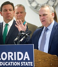 Florida Department of Education Commissioner Richard Corcoran, right, speaks alongside Gov. Ron DeSantis at a news conference on March 17.
Mandatory Credit:	Michael Snyder/The Northwest Florida Daily News/USA Today Network