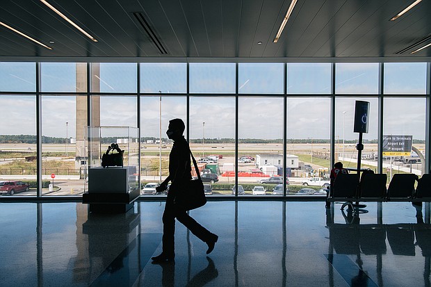 A traveler walks through the George Bush Intercontinental Airport on December 03, 2021 in Houston. A federal judge in Florida struck down on Monday the CDC mask mandate for travelers .
Mandatory Credit:	Brandon Bell/Getty Images