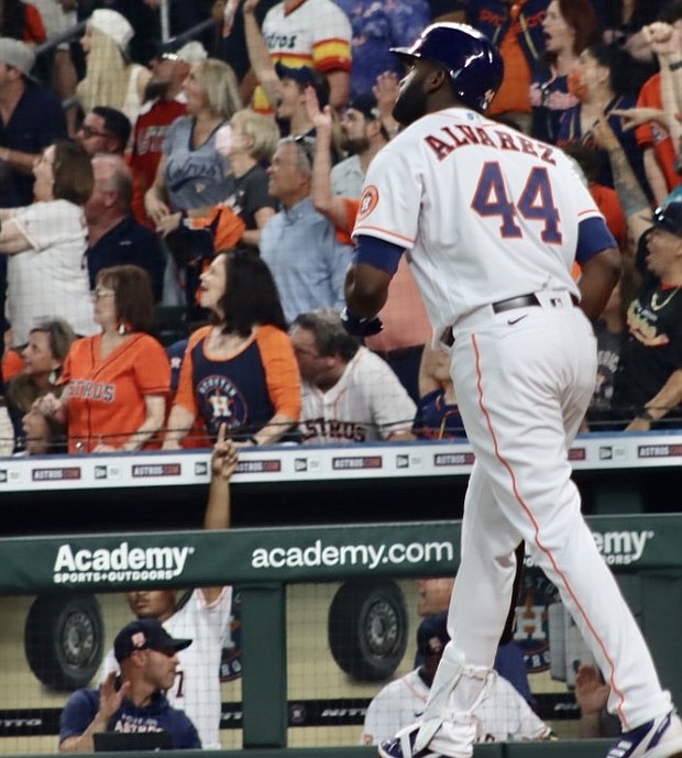 Designated Hitter Yordan Alvarez watches his two-run home run in the first inning reach the stands in right field at Minute Maid Park in the Houston Astros home opener.