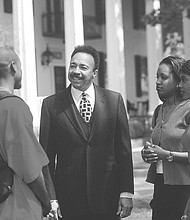 Dr. Harvey talks with students outside Mansion House, the president’s residence, located on the waterfront on the Hampton University campus. The house, built in 1828, was the main house for the plantation called Little Scotland that once stood on the grounds.