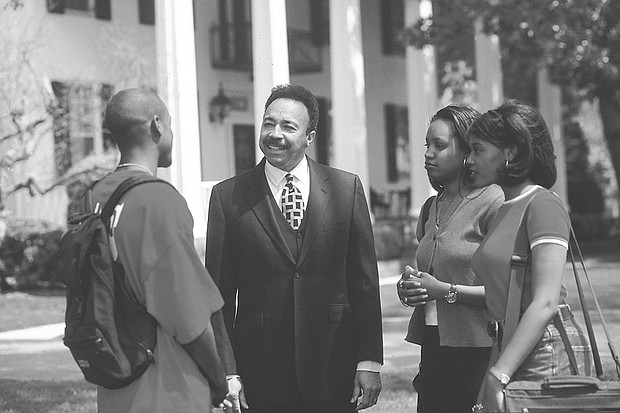 Dr. Harvey talks with students outside Mansion House, the president’s residence, located on the waterfront on the Hampton University campus. The house, built in 1828, was the main house for the plantation called Little Scotland that once stood on the grounds.