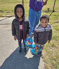 Jorel Jones, left, and his brother, Jordan, show off their impressive haul from the first annual Easter Egg Extravaganza held Sunday by the nonprofit No Residue & Co. at Lucks Field in the East End. The boys attended the egg hunt with their aunt, Briauna Saunders, and other relatives. They were among more than 60 children, mainly from Mosby Court, who participated in the fun family event. The Richmond Alumni Chapter of Kappa Alpha Psi Fraternity and P&F Contracting supported the event, with a team from the home renovation firm handling the cookout. Participants also received COVID-19 home test kits.