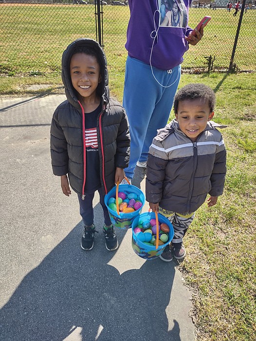 Jorel Jones, left, and his brother, Jordan, show off their impressive haul from the first annual Easter Egg Extravaganza held Sunday by the nonprofit No Residue & Co. at Lucks Field in the East End. The boys attended the egg hunt with their aunt, Briauna Saunders, and other relatives. They were among more than 60 children, mainly from Mosby Court, who participated in the fun family event. The Richmond Alumni Chapter of Kappa Alpha Psi Fraternity and P&F Contracting supported the event, with a team from the home renovation firm handling the cookout. Participants also received COVID-19 home test kits.