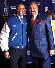 Dr. Harvey poses for a photo with President Barack Obama, who delivered the commencement address on Sunday, May 9, 2010, at Hampton University’s Armstrong Stadium to thousands of cheering students and their families. Here, President Obama wears a specialty jacket in Hampton University’s colors that was embroidered with his name and that of the university.