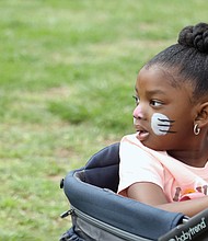 Zynik Flowers, 4, sees the fun from her seat in a wagon being guided by her mother, Kenisew Jenkins of Mechanicsville. It was a day people of all ages enjoyed.