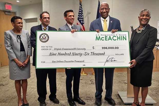 Congressman A. Donald McEachin, second from right, presents Virginia Commonwealth University officials with a ceremonial check representing a federal grant for its Gun Violence Prevention Framework. With him at the April 14 news conference are, from left, Sheryl Garland, VCU Health Innovation director; Dr. Michel B. Aboutanos, medical director of the VCU Trauma Center; VCU President Michael Rao; and Richmond Commonwealth’s Attorney Colette W. McEachin, who is the wife of Rep. McEachin.