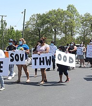 Elena Camacho, left, a community organizer with New Virginia Majority, leads a group of frustrated Southwood tenants Monday in a rally to present complaints and repair requests to the apartment management. The complex is located on Southwood Parkway off Hull Street in South Side.