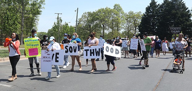 Elena Camacho, left, a community organizer with New Virginia Majority, leads a group of frustrated Southwood tenants Monday in a rally to present complaints and repair requests to the apartment management. The complex is located on Southwood Parkway off Hull Street in South Side.