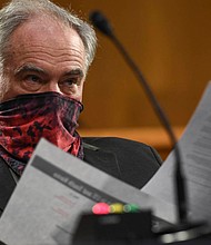 In this May 2020 photo, U.S. Sen. Tim Kaine wears a mask as he listens to testimony during a hearing before the Senate Committee for Health, Education, Labor and Pensions on Capitol Hill in Washington. Sen. Kaine, who has nerve tingling since contracting COVID-19 two years ago, recently introduced legislation to raise awareness of long COVID and treatment possibilities.